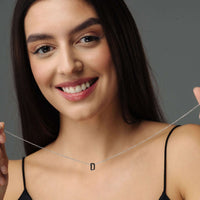 Thumbnail for Iconic Initial Necklace showcasing a personalized 'D' initial, worn by a smiling woman, by Brother & Sisters.