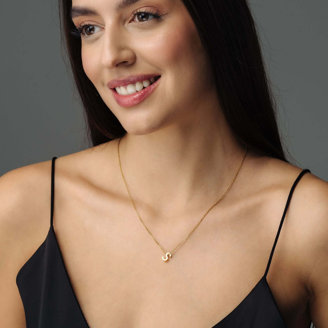 Woman wearing Iconic Initial Necklace by Brother & Sisters featuring a polished gold initial pendant.