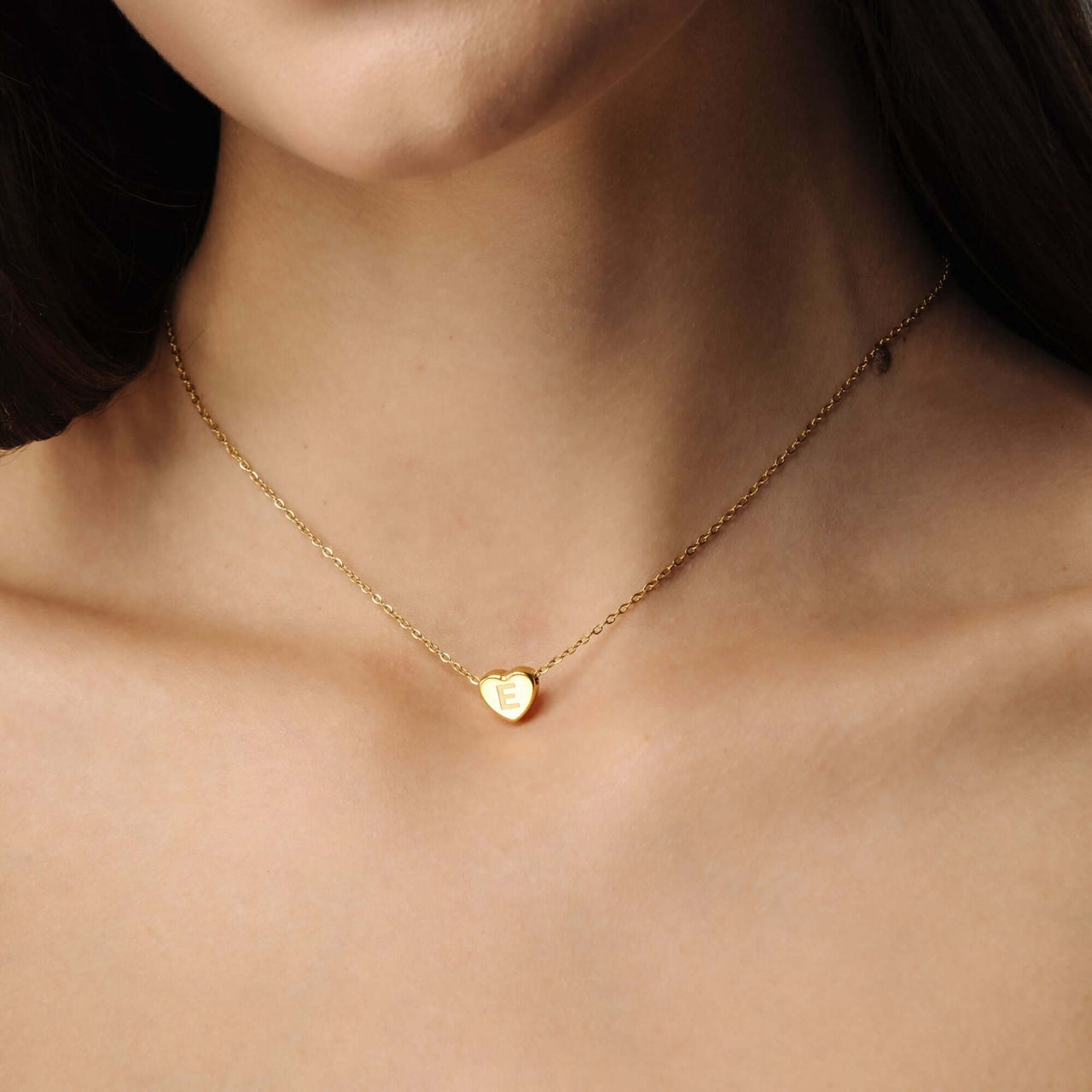 Love Initial Necklace by Brother & Sisters, featuring a gold heart charm with a personalized initial.