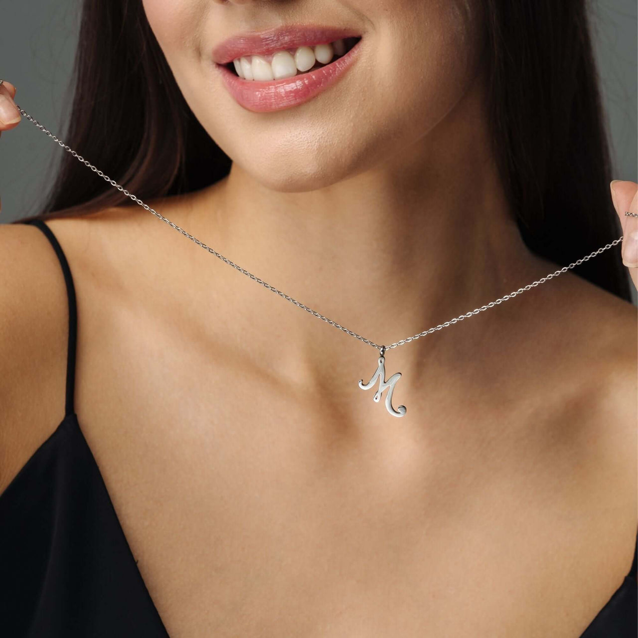 Minimalist Initial Necklace worn by a woman, featuring an elegant personalized 'M' pendant, from Brother & Sisters.