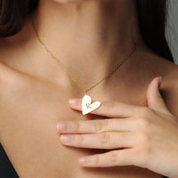Thumbnail for Romantic Initial Necklace showcasing a gold heart pendant with 'R' worn on a woman's neck by Brother & Sisters.