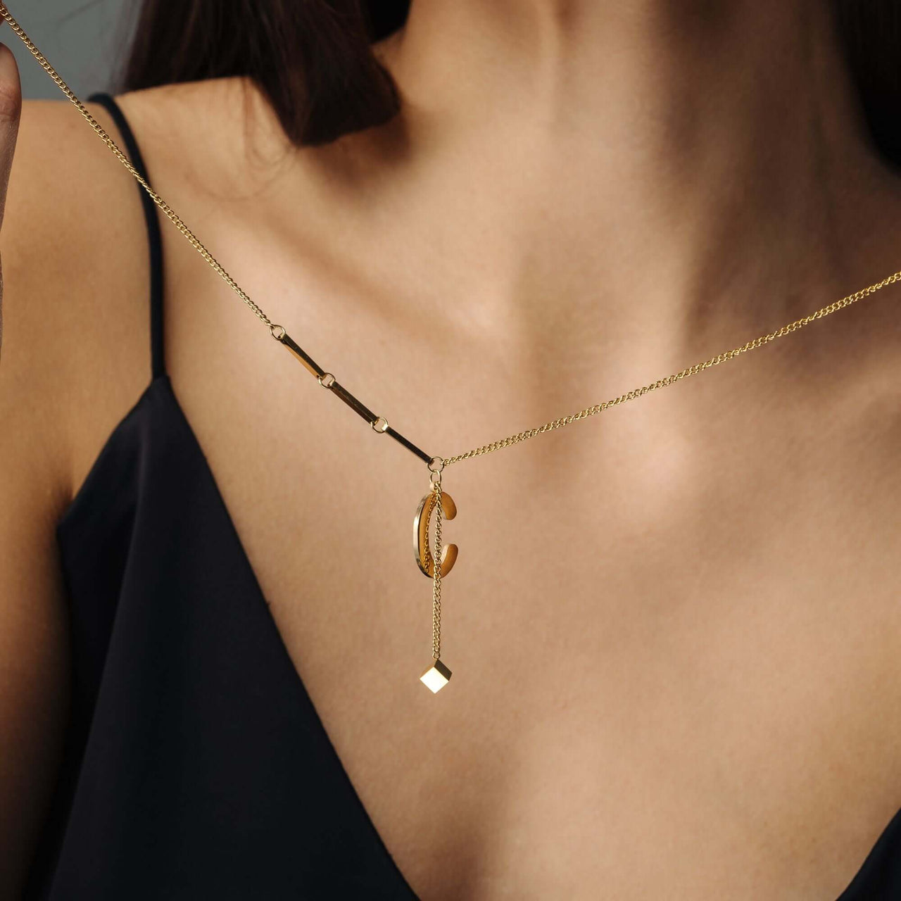 Simple Initial Necklace worn by a woman, featuring gold elegance and minimalist design by Brother & Sisters.