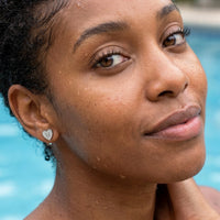 Thumbnail for Heart Initial Stud Earrings in Silver worn in a swimming pool, waterproof 304L stainless steel | SKU: heart-initial-silver-a