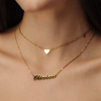 Thumbnail for Heart Name Necklace from Brother & Sisters with personalized nameplate and chic heart charm, elegantly displayed.