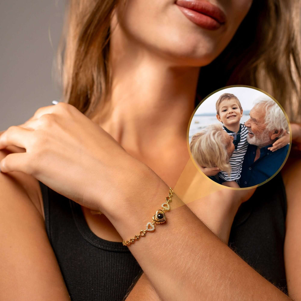 Hearts Personalised Bracelet worn by a woman, showcasing a heart-shaped pendant with a photo of loved ones.