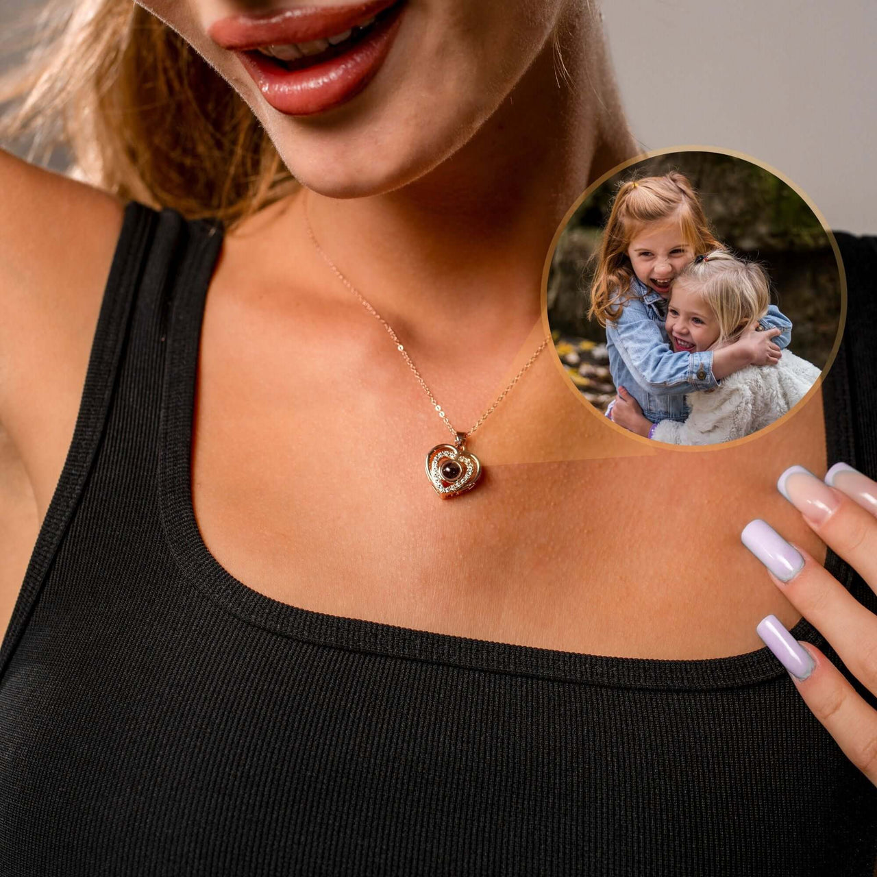 Hearts Photo Necklace worn by a woman showcasing children's photo locket, designed by Brother & Sisters.