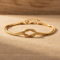 Thumbnail for Knot Couple Bracelet gold macro detail flat on wood surface