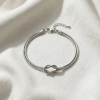 Thumbnail for Lane B v2 Knot Couple Bracelet silver single bracelet flat-lay cool ivory linen architectural