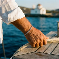 Thumbnail for Older Mediterranean man on yacht wearing His silver Heart Bond bracelet, Greek isles