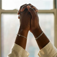 Thumbnail for Black couple raised hands joined wearing matching silver Heart Bond bracelets