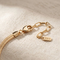 Thumbnail for Layla gold anklet macro detail — lobster clasp + paperclip extension chain + B&S engraved metal tag on cream linen