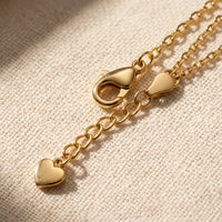 Thumbnail for Amalfi Layered Anklet macro detail — polished gold lobster clasp + extension chain + heart-charm pendant tag on cream linen, B&S signature hardware