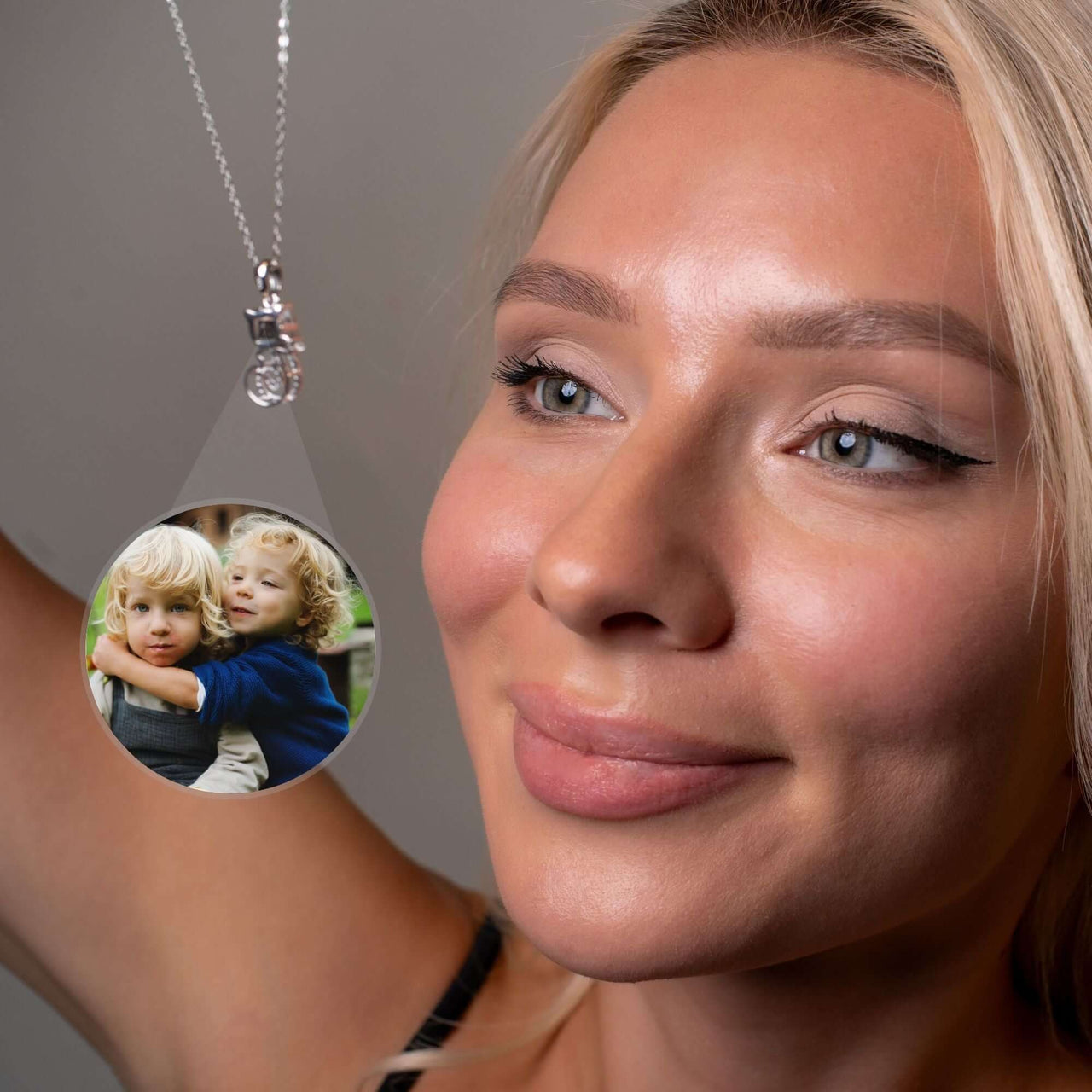 Woman wearing a Kitten Photo Necklace showcasing a personalized photo of children, by Brother & Sisters.