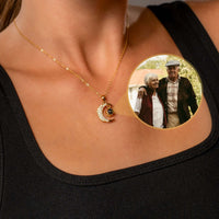 Thumbnail for Woman wearing Lucky Moon Photo Necklace by Brother & Sisters, featuring a photo projection of loved ones.