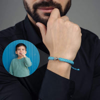 Thumbnail for Man Blue Photo Bracelet worn by a man, featuring a photo of a child embedded in the design, by Brother & Sisters.