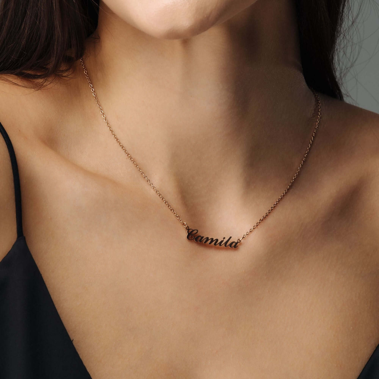 Minimalist Name Necklace worn by a woman, personalized with the name 'Camila', by Brother & Sisters.