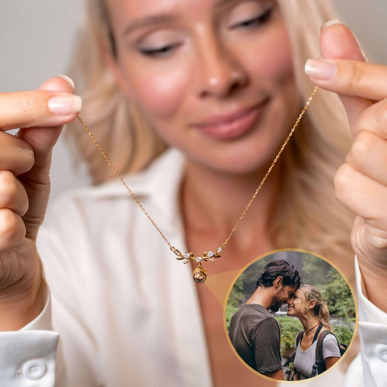 Nature Photo Necklace by Brother & Sisters held by a woman, featuring a personal photo projection for special memories.