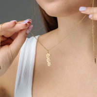 Thumbnail for Paw Name Necklace worn by a model showcasing its personalized design and elegant gold finish by Brother & Sisters.