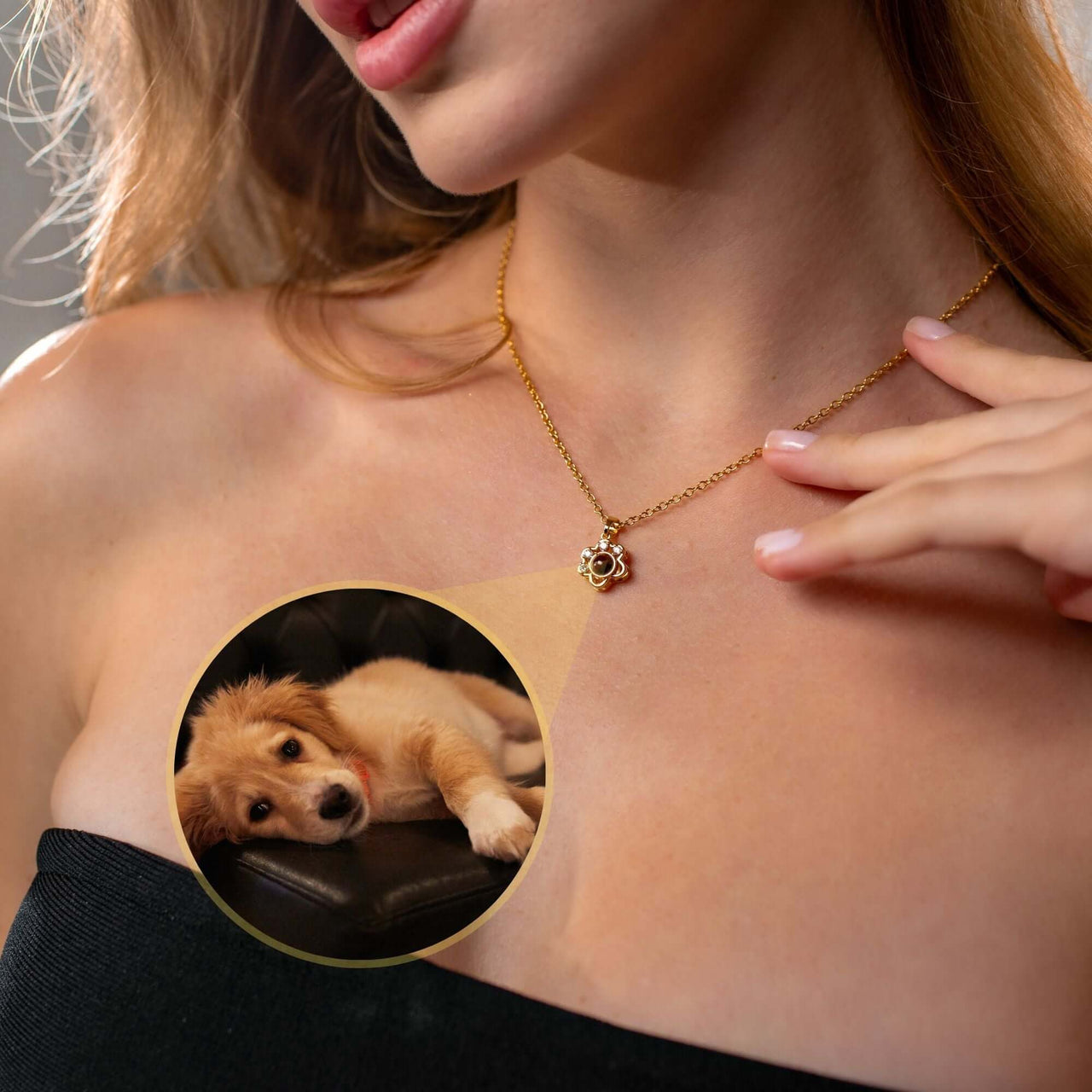 A woman wearing a Paw Print Photo Necklace by Brother & Sisters, showcasing a projection of her pet.
