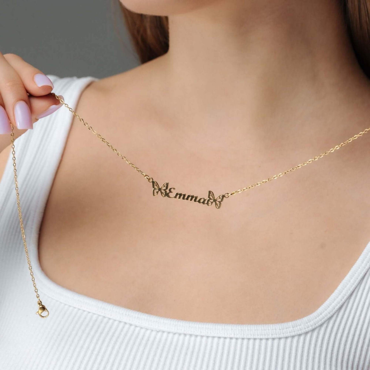 Butterfly Name Necklace displayed on a model, featuring the name Emma, designed by Brother & Sisters.