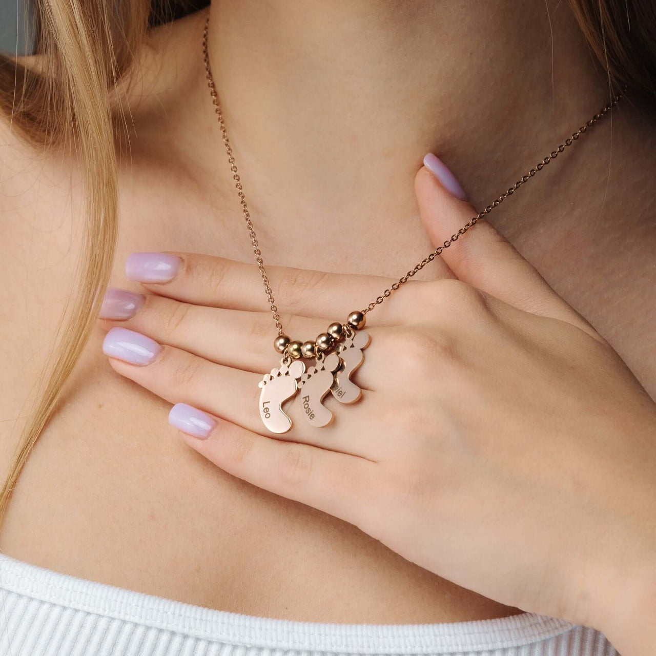 Child Name Necklace by Brother & Sisters, featuring a personalized design with scattered charms on a delicate chain.