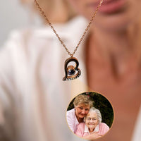 Thumbnail for Romantic Photo Necklace by Brother & Sisters with a heart design projecting a cherished photo of loved ones.