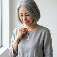 Thumbnail for Woman moved as she looks at her late husband's photo in the silver bar necklace | SKU: TPH-BARN-SILVER