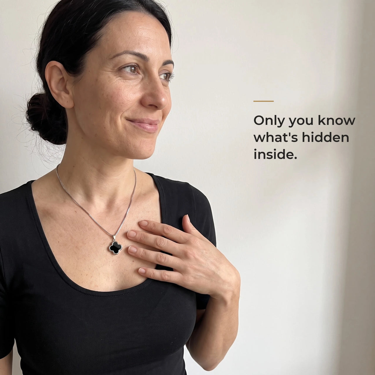 Woman in a black top touching the black clover pendant on its silver chain, only she knows the photo inside | SKU: TPH-CLVN-SILVER