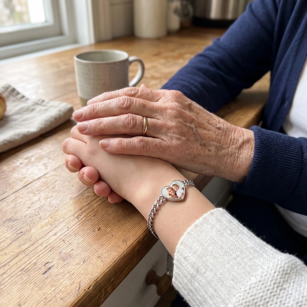 Grandmother's hand on her granddaughter's, the silver heart photo bracelet on her wrist | SKU: TPH-HRTB-SILVER