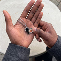 Thumbnail for Thumb warming the silver heart pendant: the hidden photo appears under the thumb while the rest stays black | SKU: TPH-HRTN-SILVER