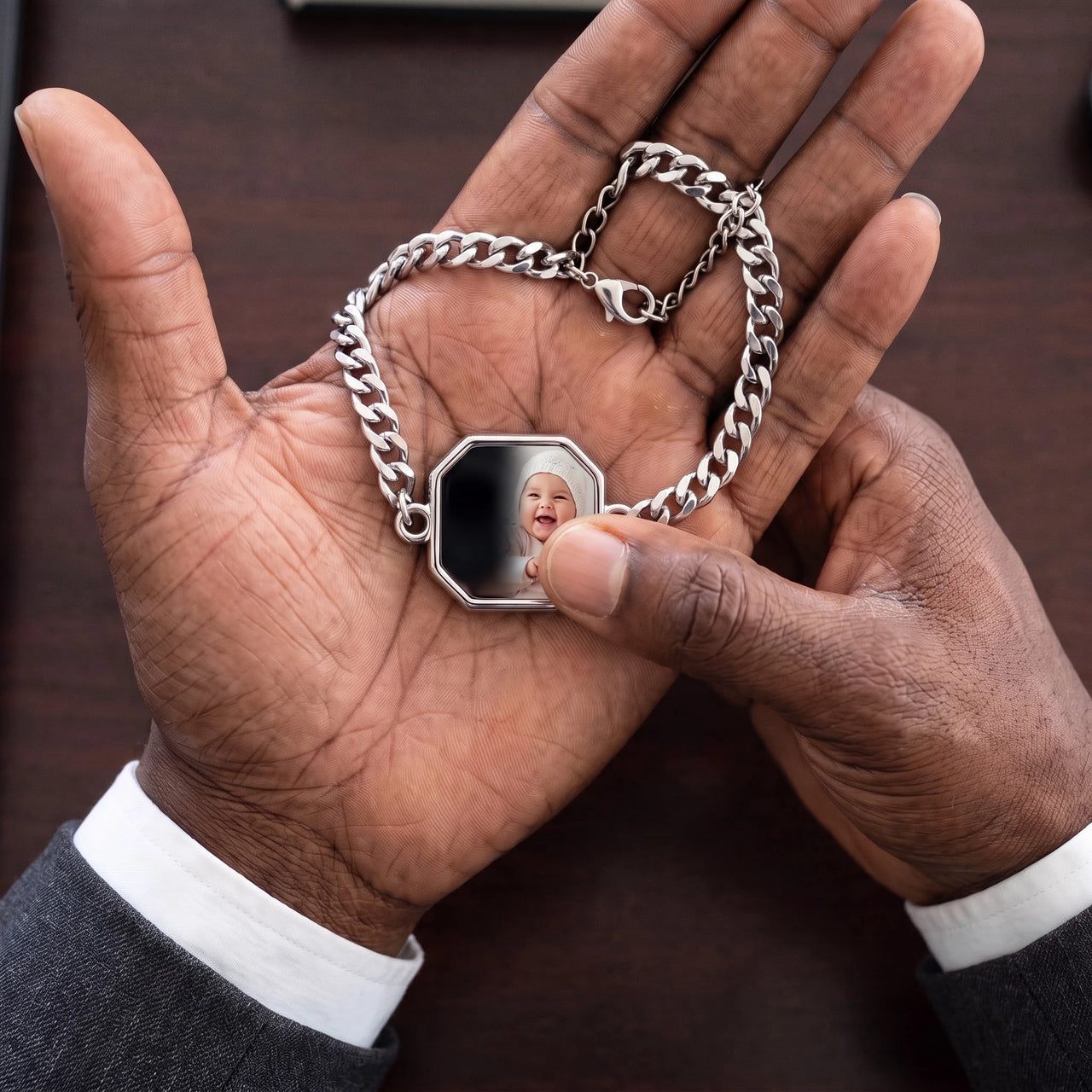 Thumb warming the silver octagon bracelet plate: the hidden photo appears under the thumb while the rest stays black | SKU: TPH-OCTB-SILVER-18