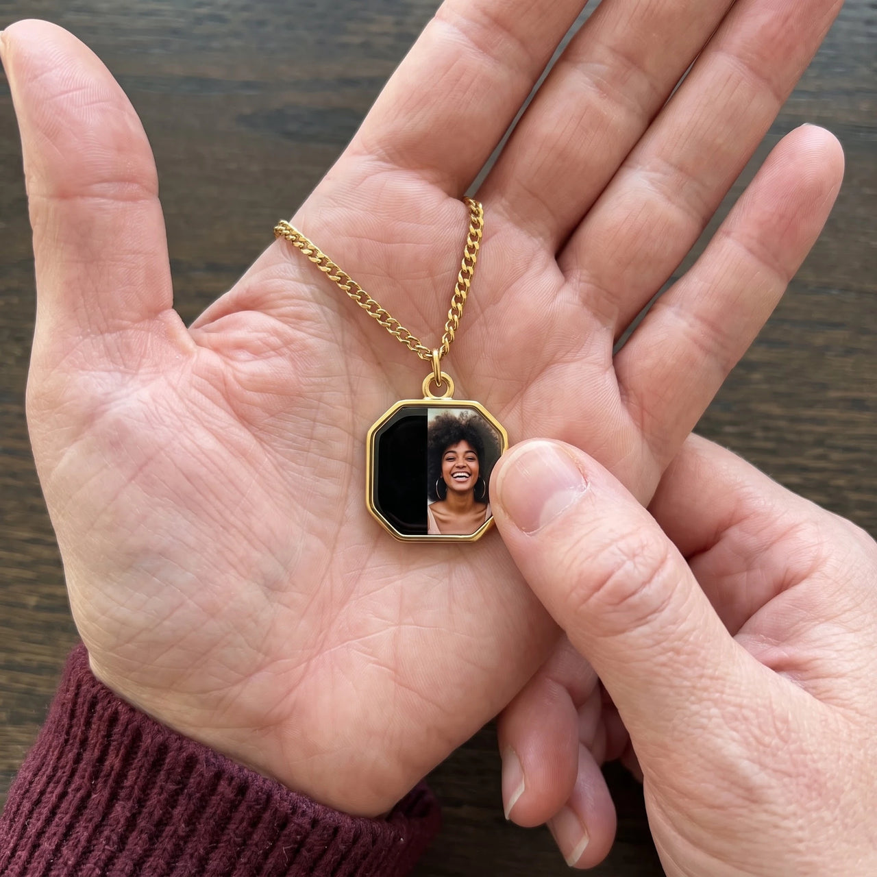 Thumb warming the gold octagon pendant: the hidden photo appears under the thumb while the rest stays black | SKU: TPH-OCTN-GOLD