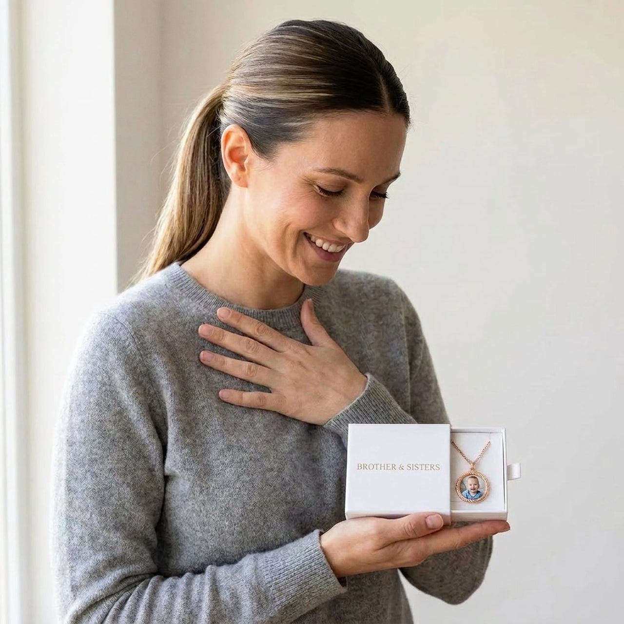 The rose gold round photo necklace with her baby's photo in the Brother & Sisters gift box | SKU: TPH-RNDN-ROSEGOLD