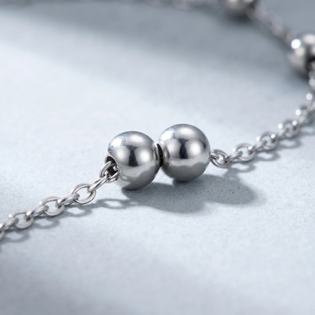 Close-up of the Silver Bead Anklet by Brother & Sisters featuring polished silver beads on a delicate chain.
