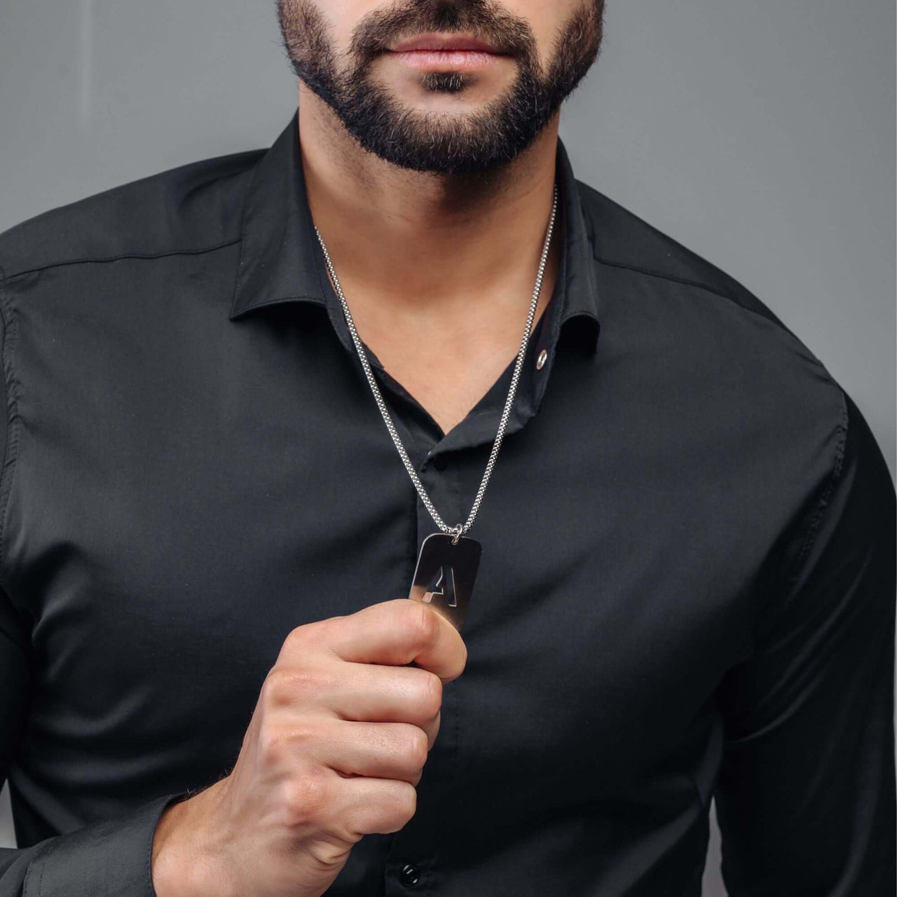 Man wearing Silver Army Initial Necklace by Brother & Sisters, showcasing military-inspired style and personalized elegance.