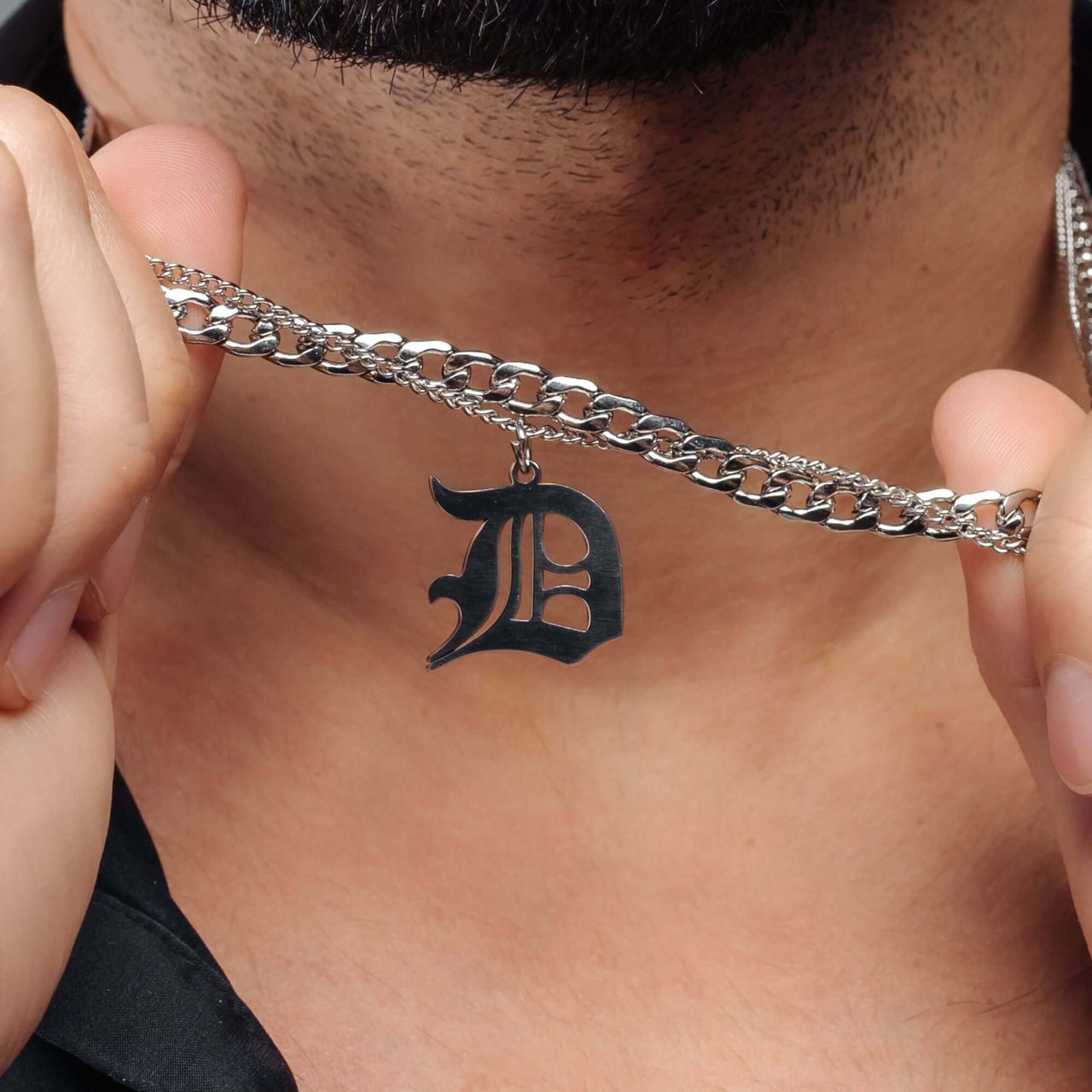 Man showcasing Brother & Sisters Unique Initial Necklace with a stylish letter pendant on a silver chain.