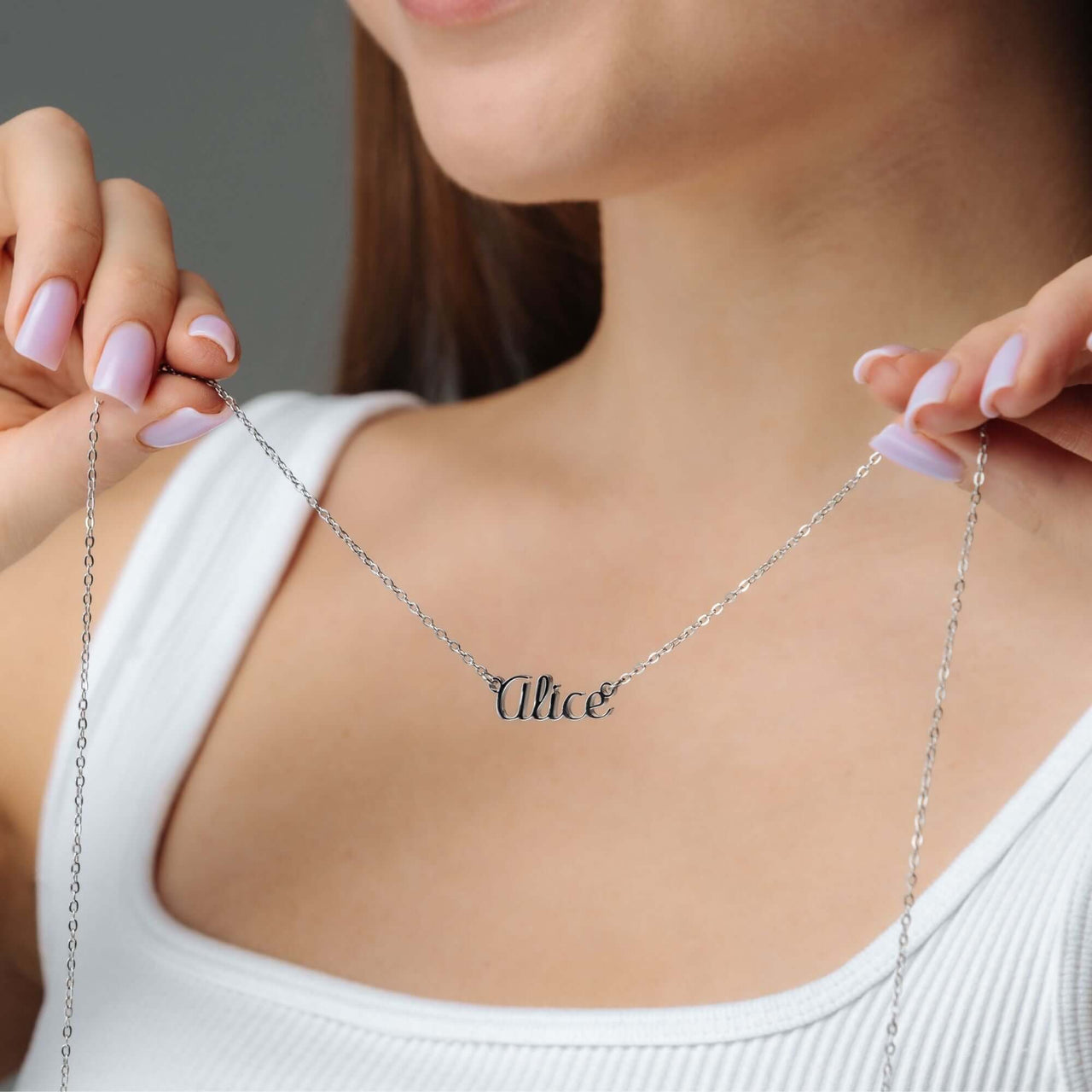 Silver Name Necklace showcased on a model, featuring personalized name design by Brother & Sisters.