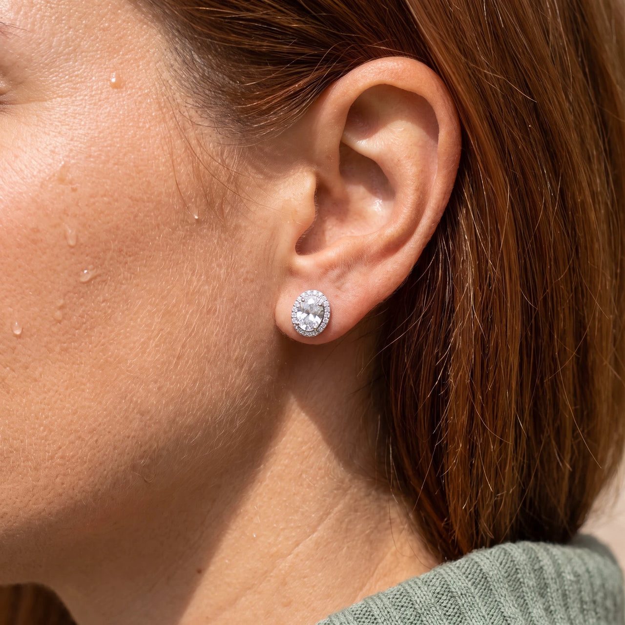 Close-up of the silver stud earrings worn on the skin | SKU: 6306968-white