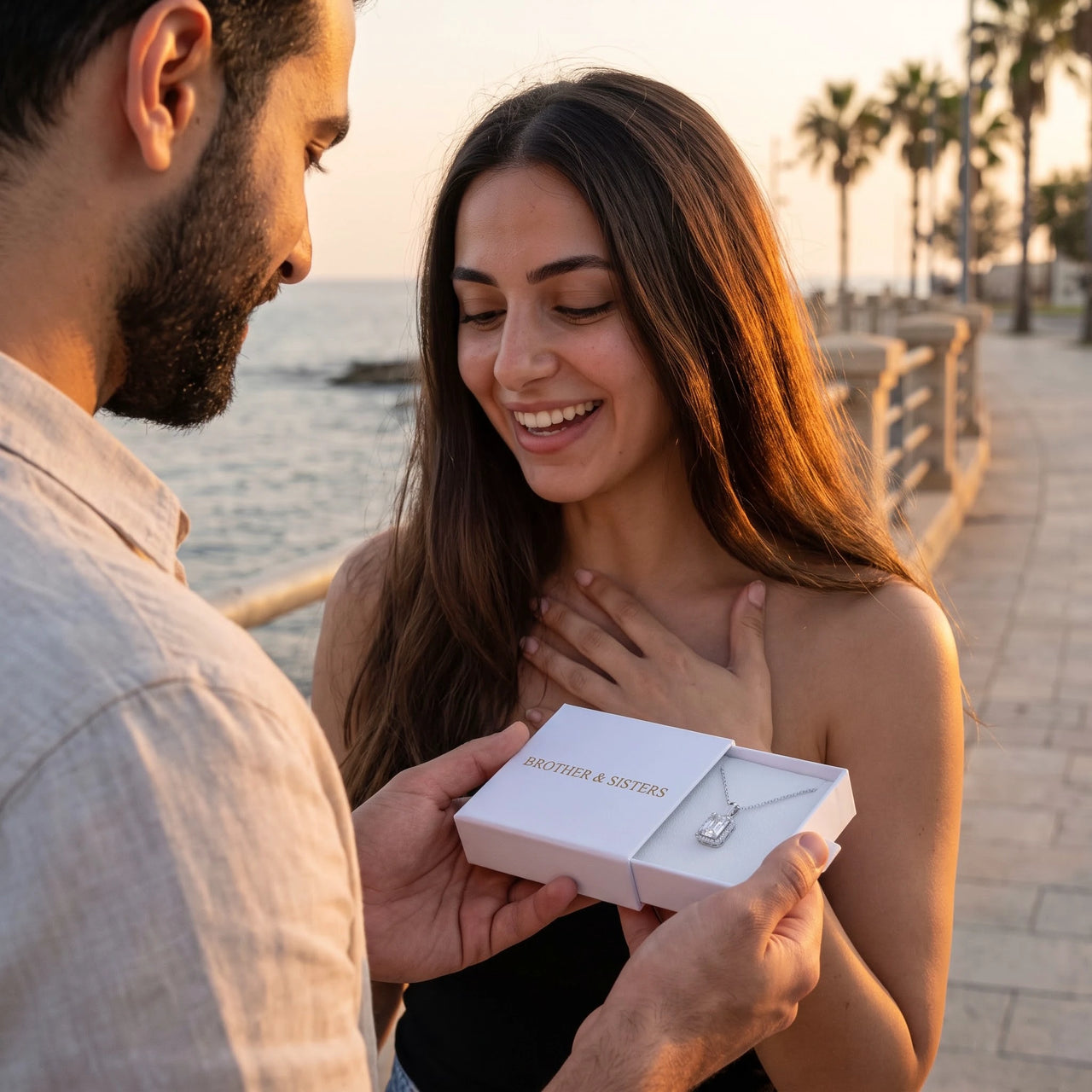 He surprises her with the silver necklace in its gift box | SKU: 22559056