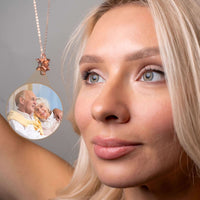 Thumbnail for Woman wearing a Snowflake Photo Necklace showcasing a cherished photo, perfect for personalized gifts by Brother & Sisters.