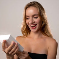 Thumbnail for Excited woman unboxing her custom Cat Photo Necklace from Brother & Sisters.