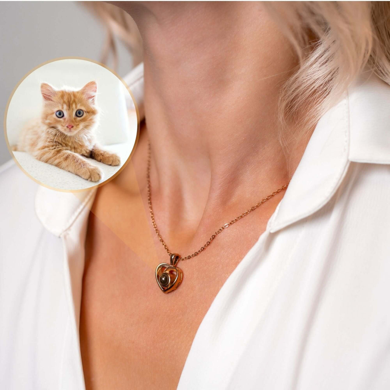 Woman wearing Timeless Photo Necklace featuring a heart-shaped locket with a photo of a cute cat, by Brother & Sisters.
