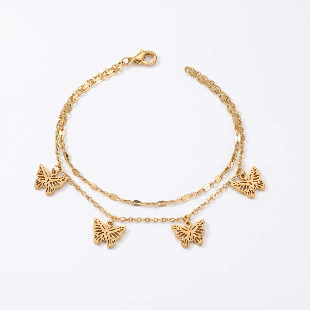 Butterfly layered anklet in gold stainless steel, four openwork butterfly charms, 22 cm, lobster clasp, on white background.