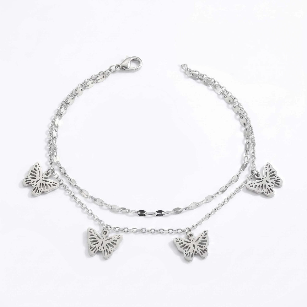 Butterfly layered anklet in silver stainless steel, four openwork butterfly charms, 22 cm, lobster clasp, on white background.