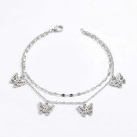 Thumbnail for Butterfly layered anklet in silver stainless steel, four openwork butterfly charms, 22 cm, lobster clasp, on white background.