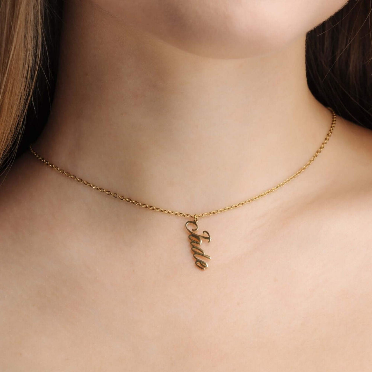 Vertical Name Necklace by Brother & Sisters, featuring a gold chain with the name Jade in a modern vertical design.