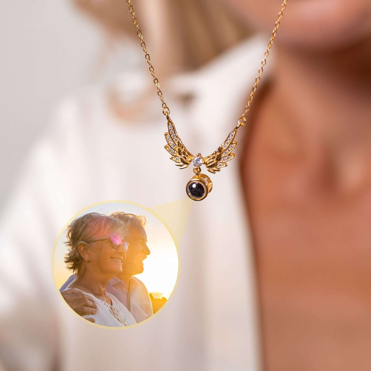 Wings Photo Necklace from Brother & Sisters featuring personalized photo encased in angel wings.