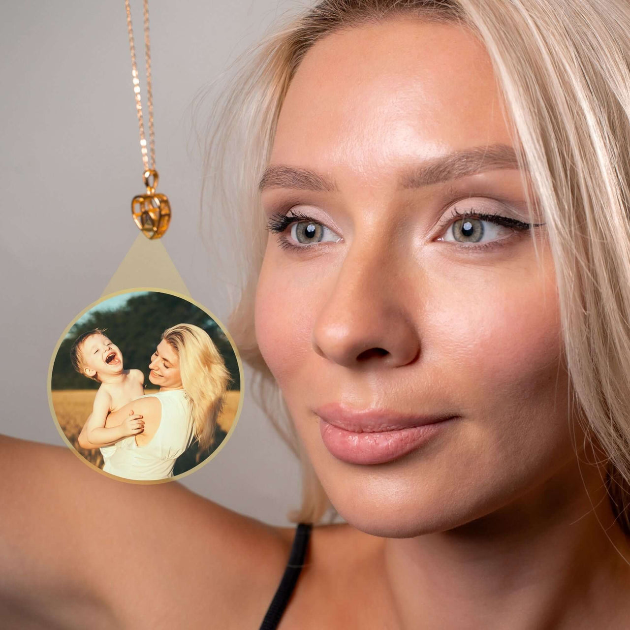 Woman modeling a Winter Photo Necklace featuring a cherished family photo by Brother & Sisters.